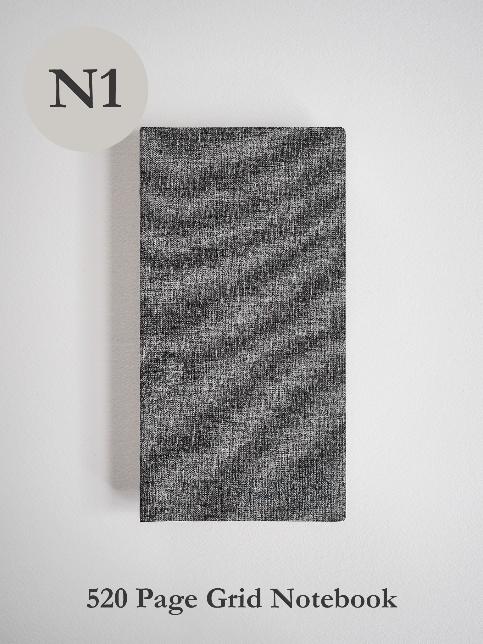 Dark charcoal notebook featuring a subtly woven texture and solid cover, designed for general notes, sketching, or grid work.