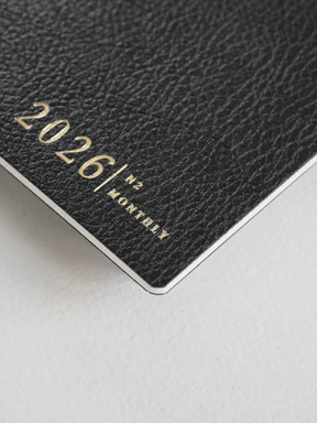 Elegant black, textured booklet cover displaying the title "2026 | N2 MONTHLY" in sophisticated gold lettering.