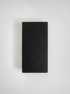 Solid black, rectangular notebook featuring a smooth, durable matte cover ideal for writing and planning.