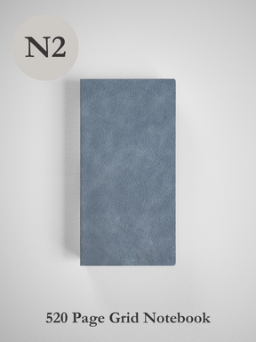 Sleek, solid slate-gray notebook featuring a subtly textured, minimalist cover ideal for 520 pages of grid note-taking.