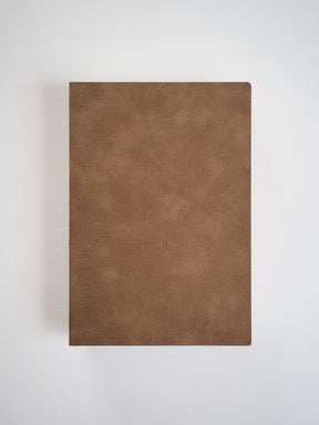 Solid mocha brown, textured faux leather notebook cover, offering a timeless, rustic, and sophisticated look for writing and journaling.