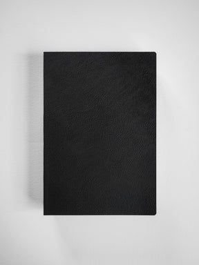 Sleek black A5 grid notebook featuring a smooth, matte, textured faux-leather cover, ideal for journaling or academic planning.