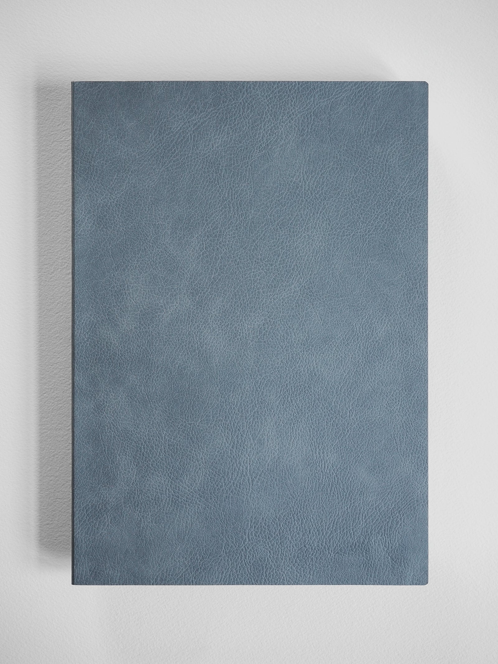 Minimalist B5 notebook featuring a richly textured, matte slate gray faux leather cover, ideal for professional journaling.