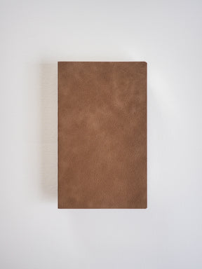 Solid, matte brown B6 grid notebook featuring a minimalist, uniform cover ideal for journaling or daily planning.