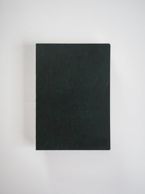 Deep black B6 grid notebook featuring a textured, durable cover, ideal for detailed journaling, work notes, and planned organization.