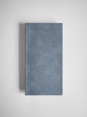 Solid slate blue grid notebook featuring a minimalist, smooth faux leather cover ideal for journaling and structured note-taking.