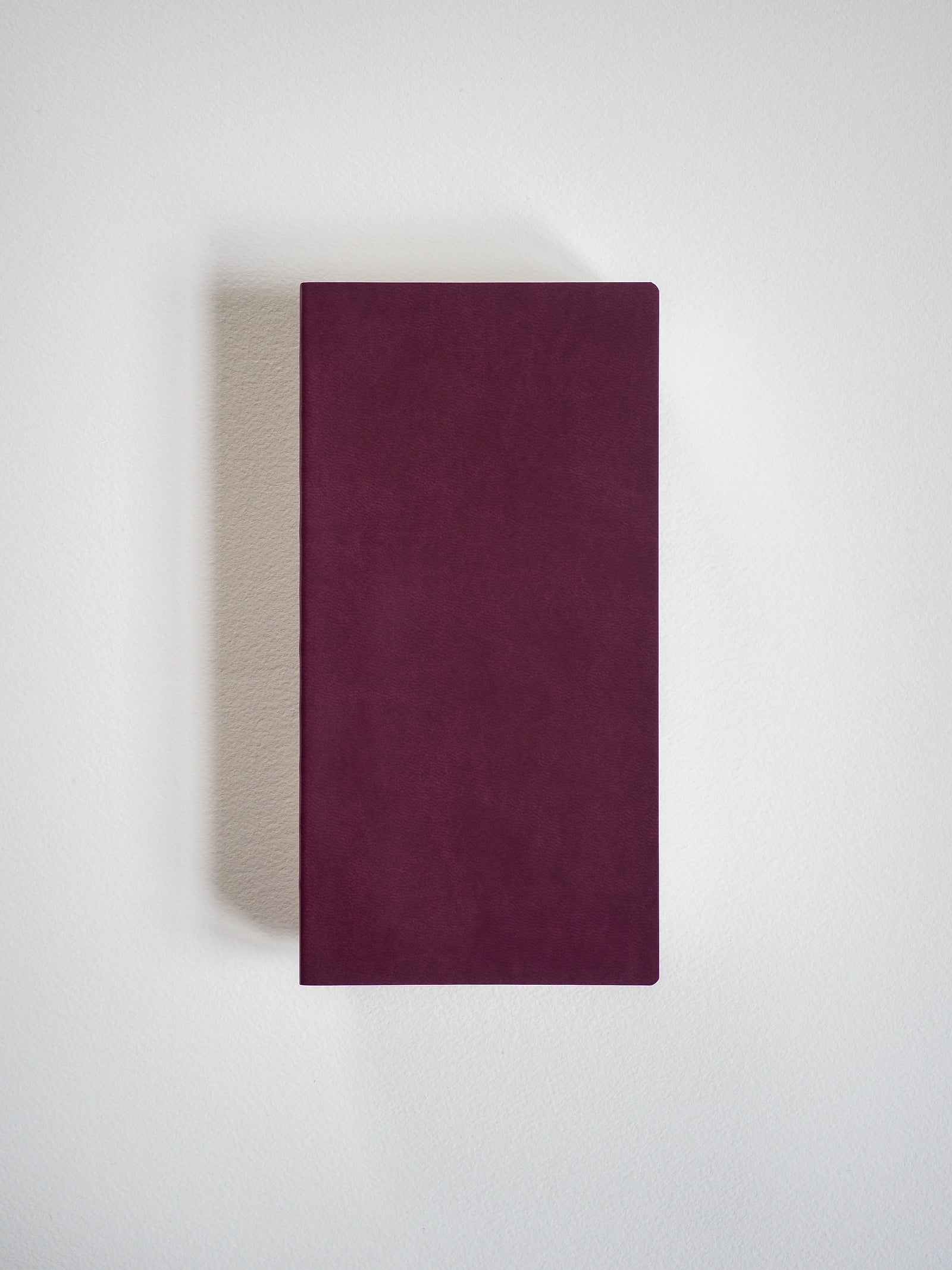 Solid deep burgundy notebook cover, displaying a clean, matte, unadorned rectangular surface perfect for writing.
