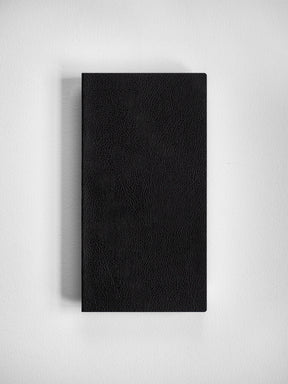 Minimalist black notebook cover with a sophisticated, deep-grained faux leather finish, perfect for journaling and planning.
