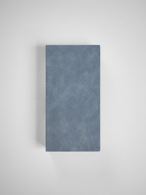 Matte dusty blue grid notebook with a textured faux leather cover, ideal for structured planning, writing, and organized weekly notes.