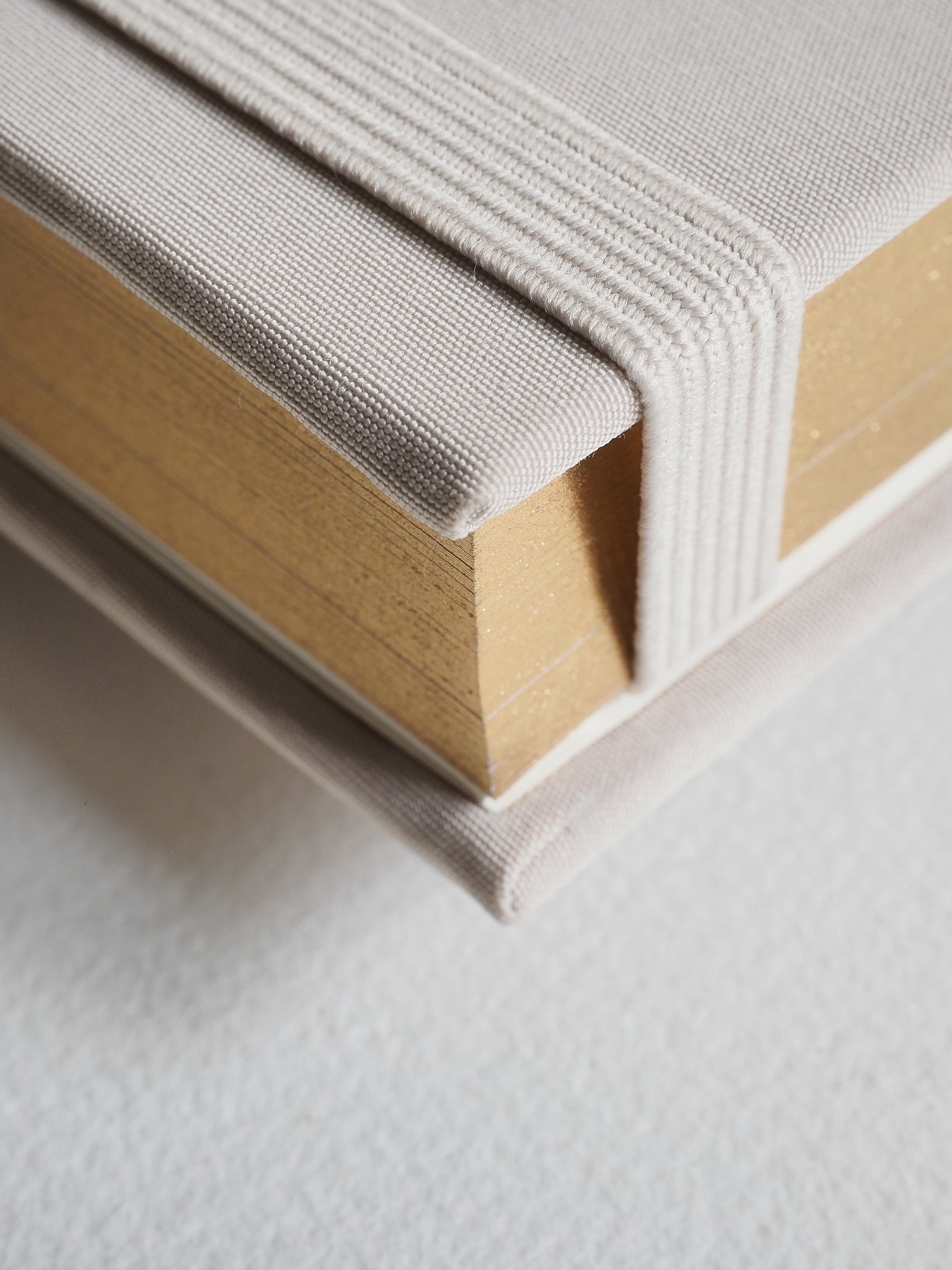 Light beige B6 hardcover diary with a textured fabric cover, showing thick, cream-colored pages inside.