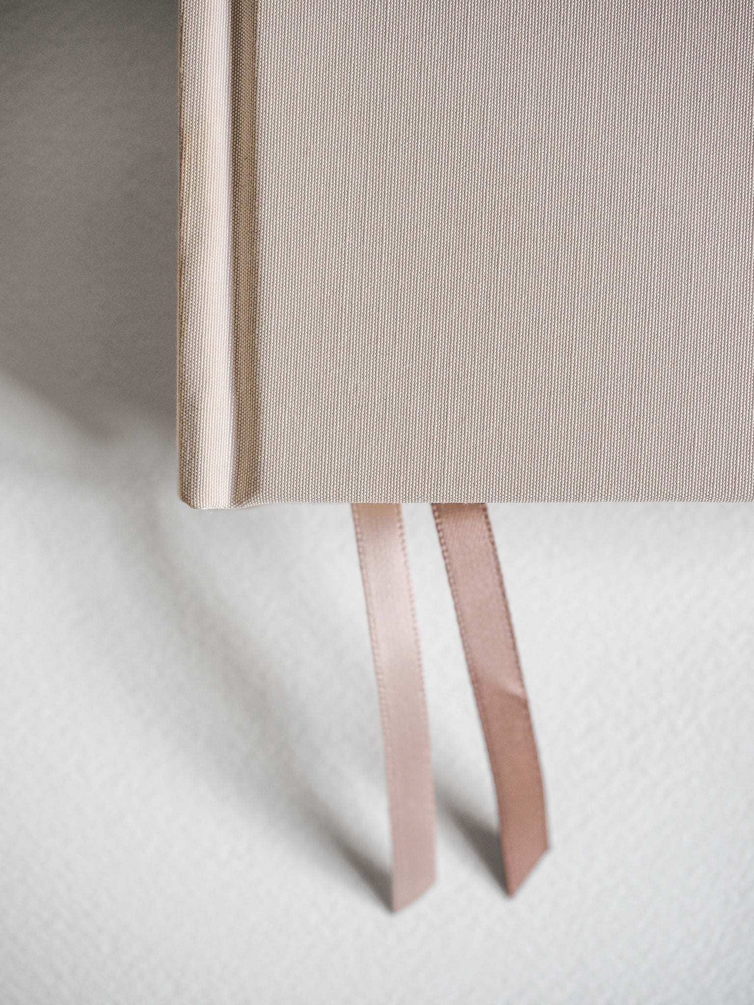 Natural linen-textured hardcover diary with a light beige finish and attached pale ribbon bookmarks, perfect for an undated five-year record.