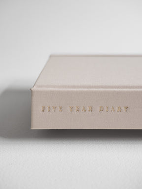 Minimalist B6 hardcover diary in a natural beige tone, featuring "Five Year Diary" subtly embossed across the center.