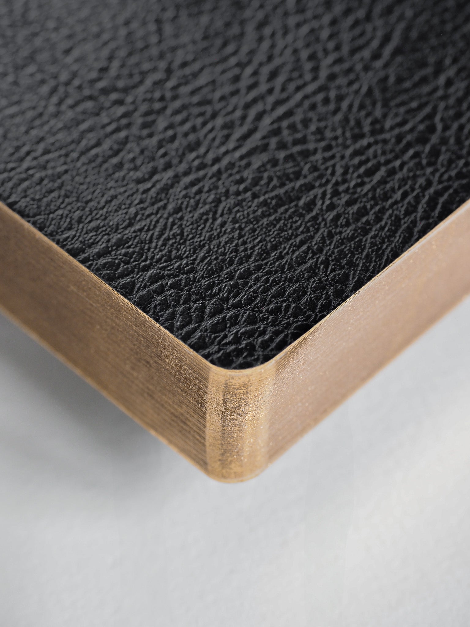 Undated A5 planner featuring a textured black interior and elegant gold-toned trim, ideal for year-round planning and journaling.