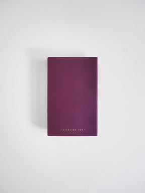 Deep plum pocket notebook featuring a solid matte cover and centered "STERLING INK" branding.