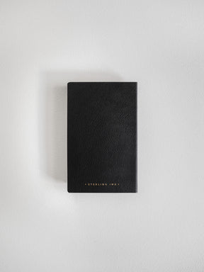 Matte black pocket notebook featuring a minimalist design and subtle gold-stamped "Sterling Ink" lettering on the cover.