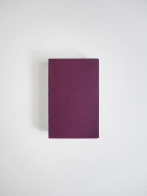 A solid, deeply hued plum notebook with a minimalist cover, ready for journaling or structured note-taking.