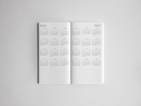 Open academic planner featuring structured, vertically aligned scheduling pages for 2026 and 2027, designed for comprehensive full-year academic tracking.