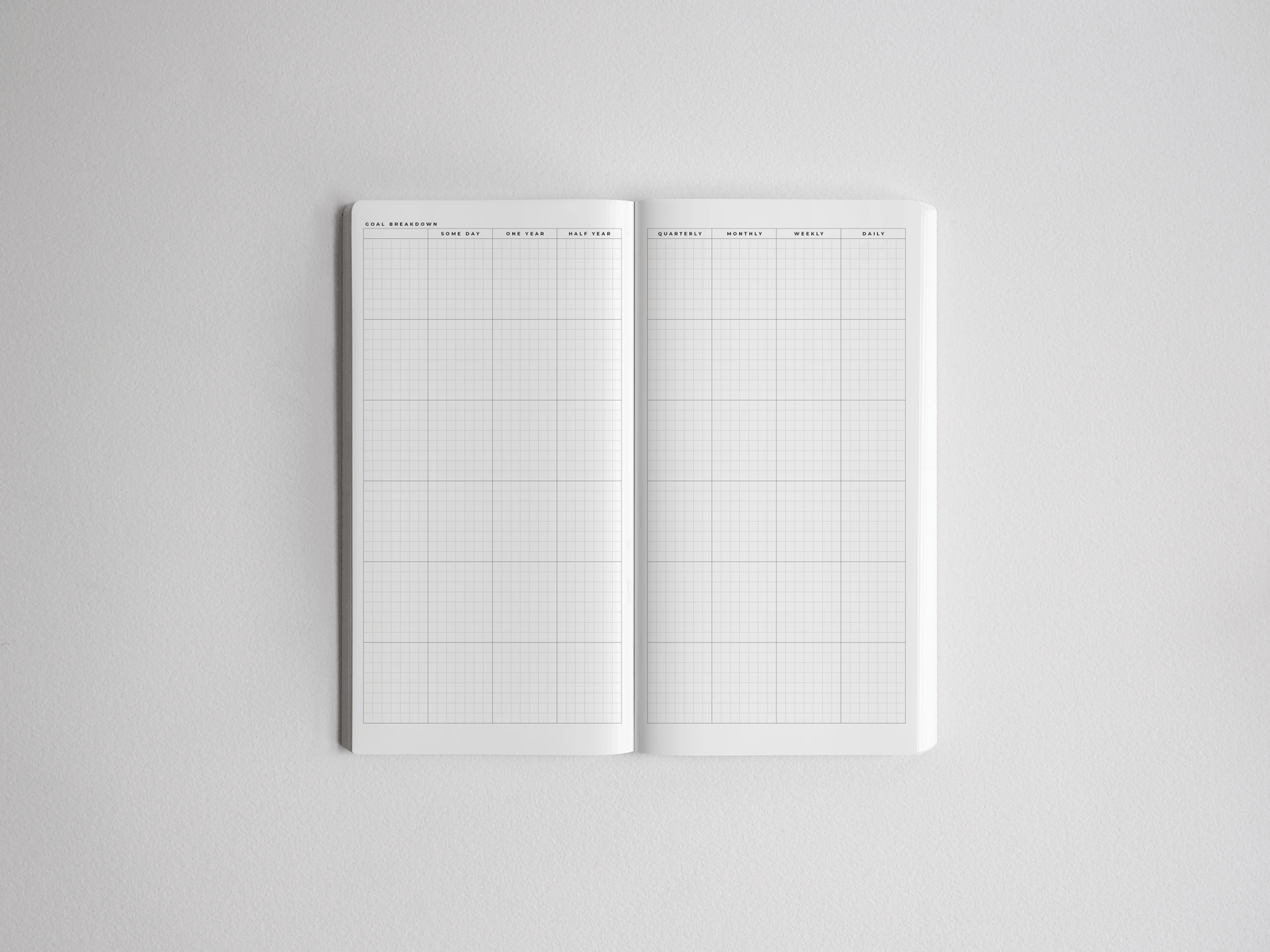 Open academic planner showing a comprehensive, white ruled grid designed for organizing daily, weekly, monthly, and yearly schedules.