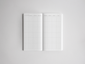 Open academic planner showing a comprehensive, white ruled grid designed for organizing daily, weekly, monthly, and yearly schedules.