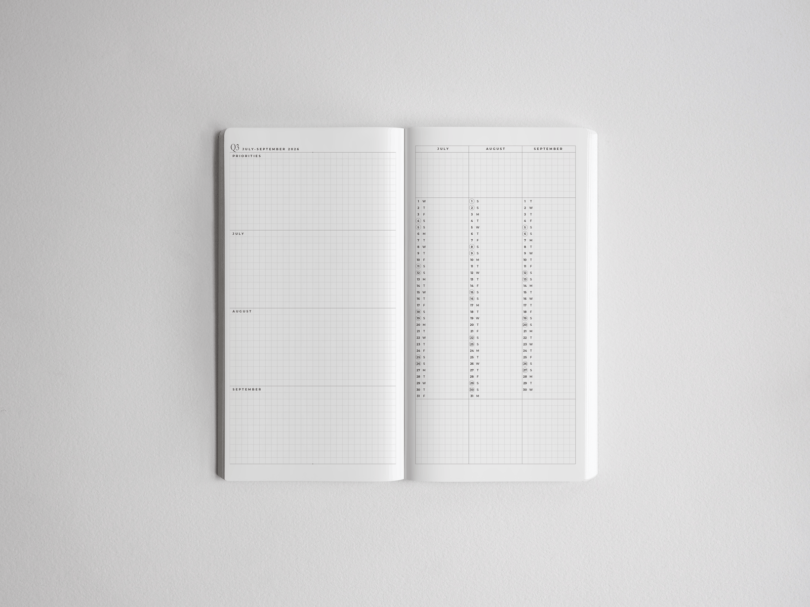 Minimalist white academic planner showing an open spread with structured weekly sections, perfect for comprehensive year-long academic goal setting.