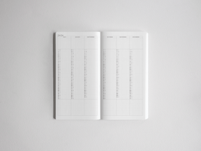 Open academic daily planner displaying structured monthly calendar spreads and ruled daily grids for comprehensive year-long planning from 2026 to 2027.
