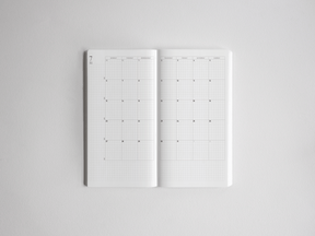 Open academic planner featuring crisp, white, horizontally oriented gridded pages designed for comprehensive annual scheduling and tracking for the 2026-2027 school year.