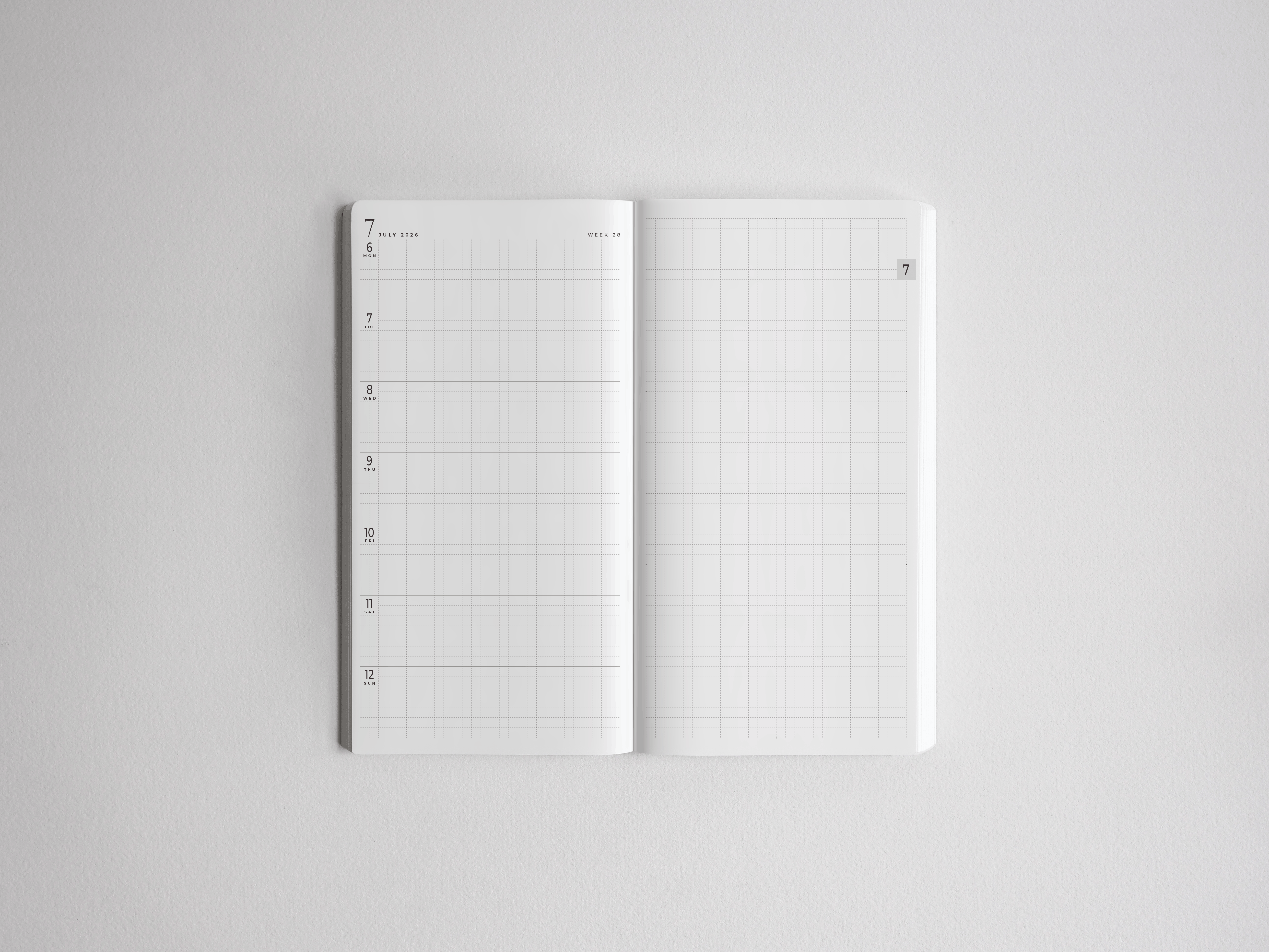 Academic full-year planner open to reveal a structured monthly date layout and complementary squared graph paper for comprehensive academic note-taking.