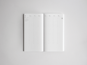 Open white academic planner displaying a clear, minimalist weekly spread grid ready for scheduling the 2026-2027 academic year.