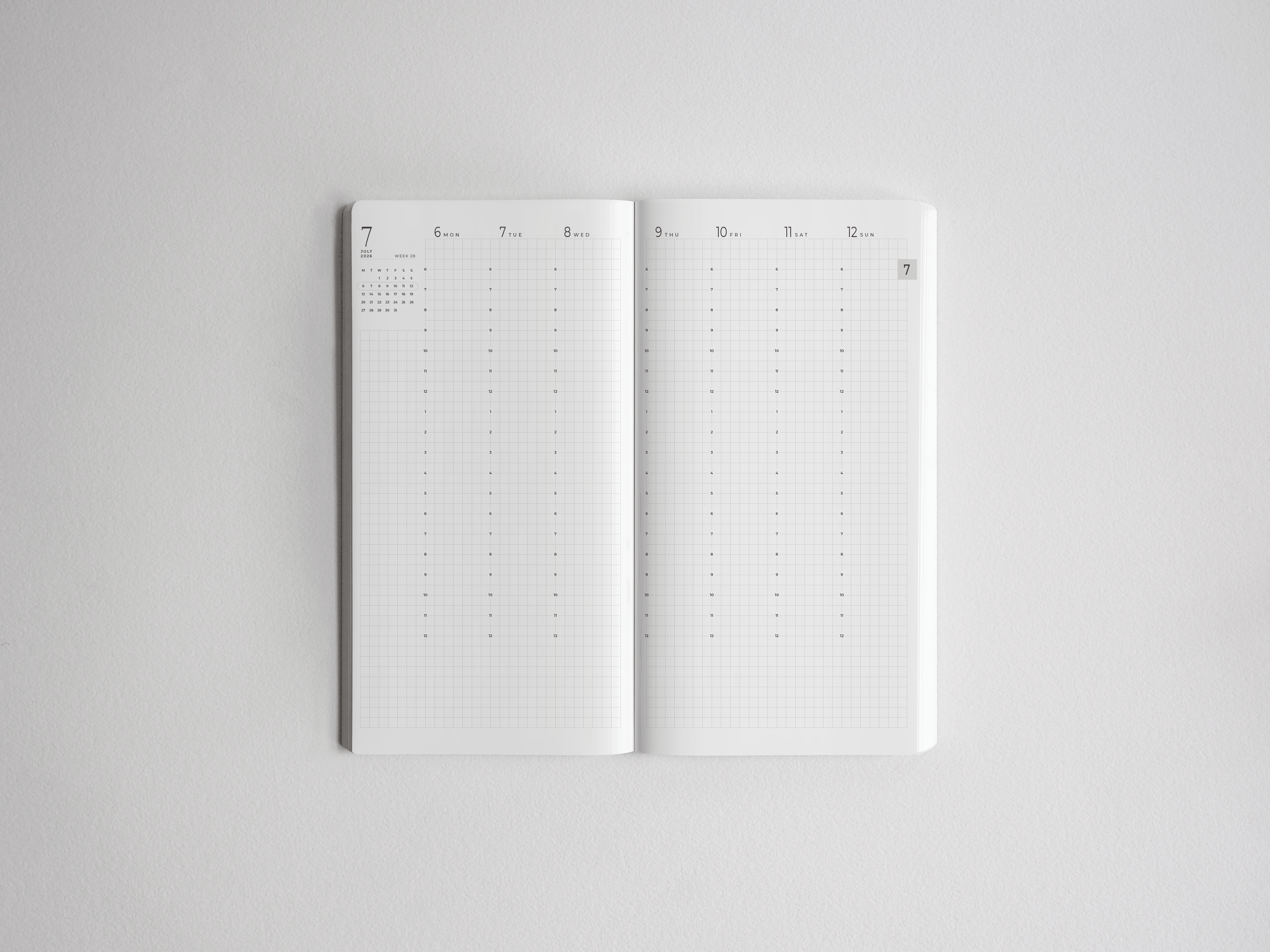 Open white academic planner displaying a clear, minimalist weekly spread grid ready for scheduling the 2026-2027 academic year.