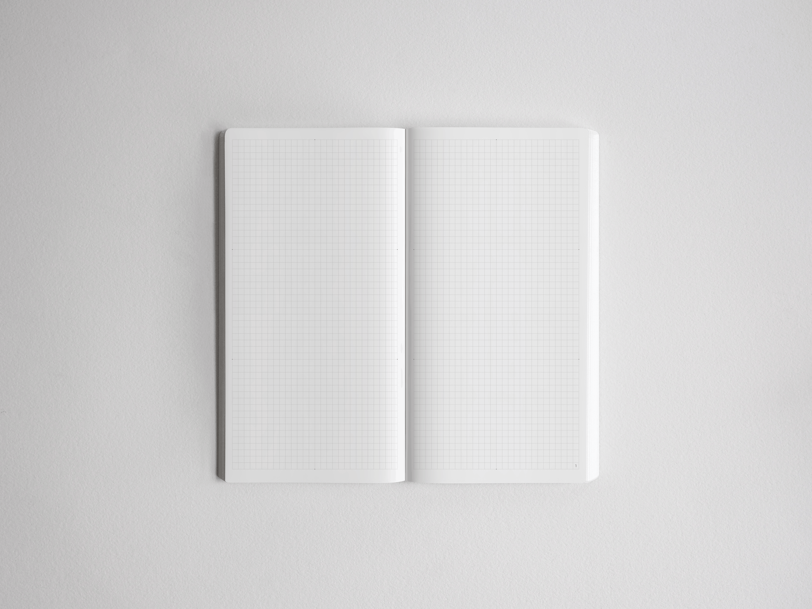 Open academic planner pages displaying uniform, faint graphite grid paper, ideal for detailed daily note-taking, academic planning, and journaling.