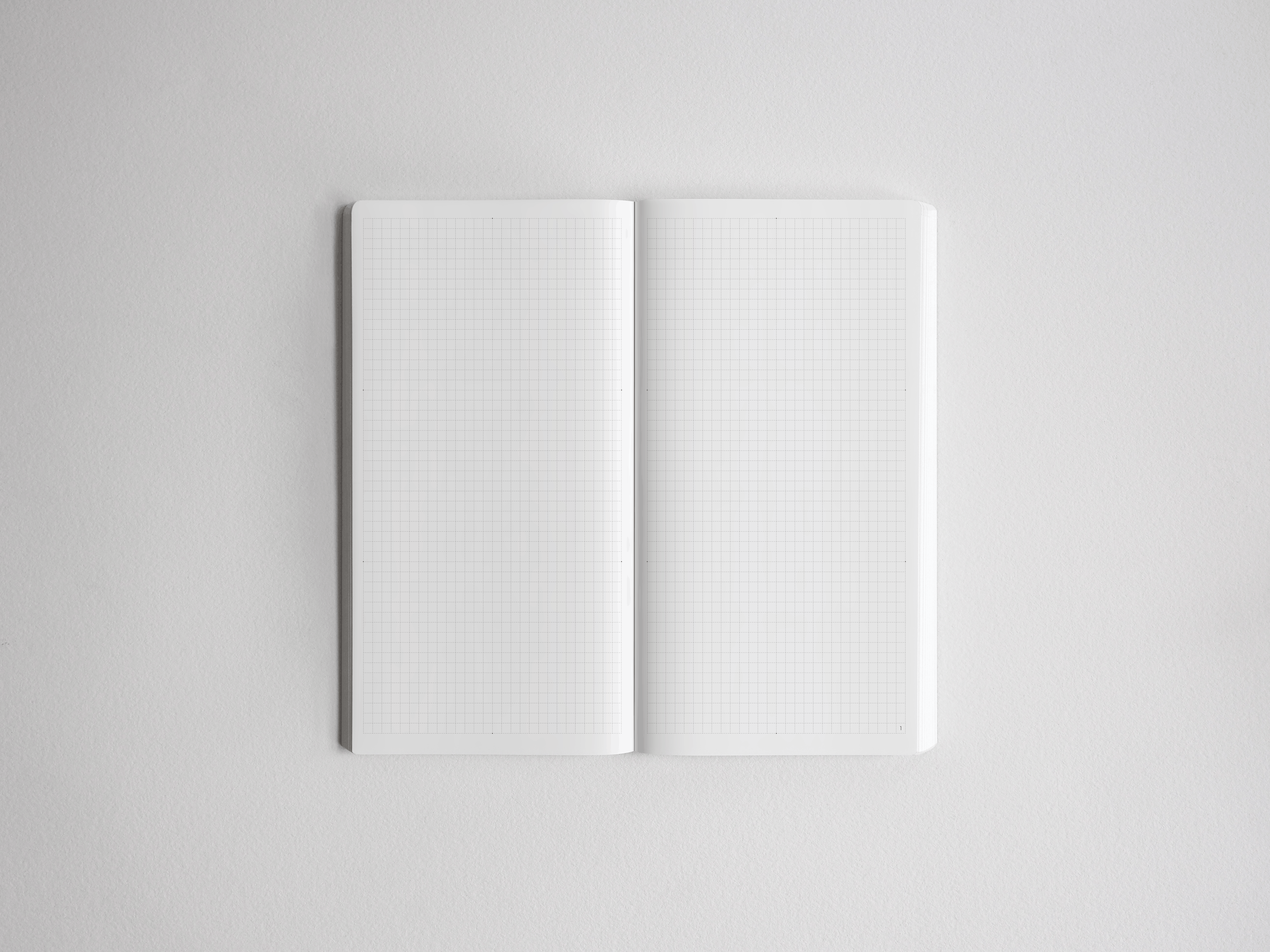Open academic planner featuring two blank pages covered entirely in faint, light gray graph paper grids ready for notes and scheduling.