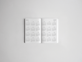 Open white pocket daily academic planner displaying detailed, full-year structured grids for both 2026 and 2027.