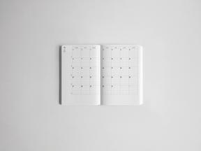 Minimalist white academic daily planner featuring an organized, spacious grid layout for tracking dates and scheduling throughout the full year.