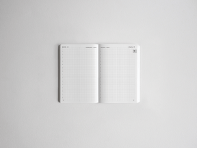 Open pocket daily planner featuring gridded, minimalist white pages perfect for academic scheduling and detailed goal tracking for 2026-2027.