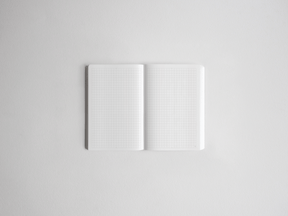 Open daily planner showing two pages of uniform white graph paper, ready for academic scheduling, note-taking, or year planning.