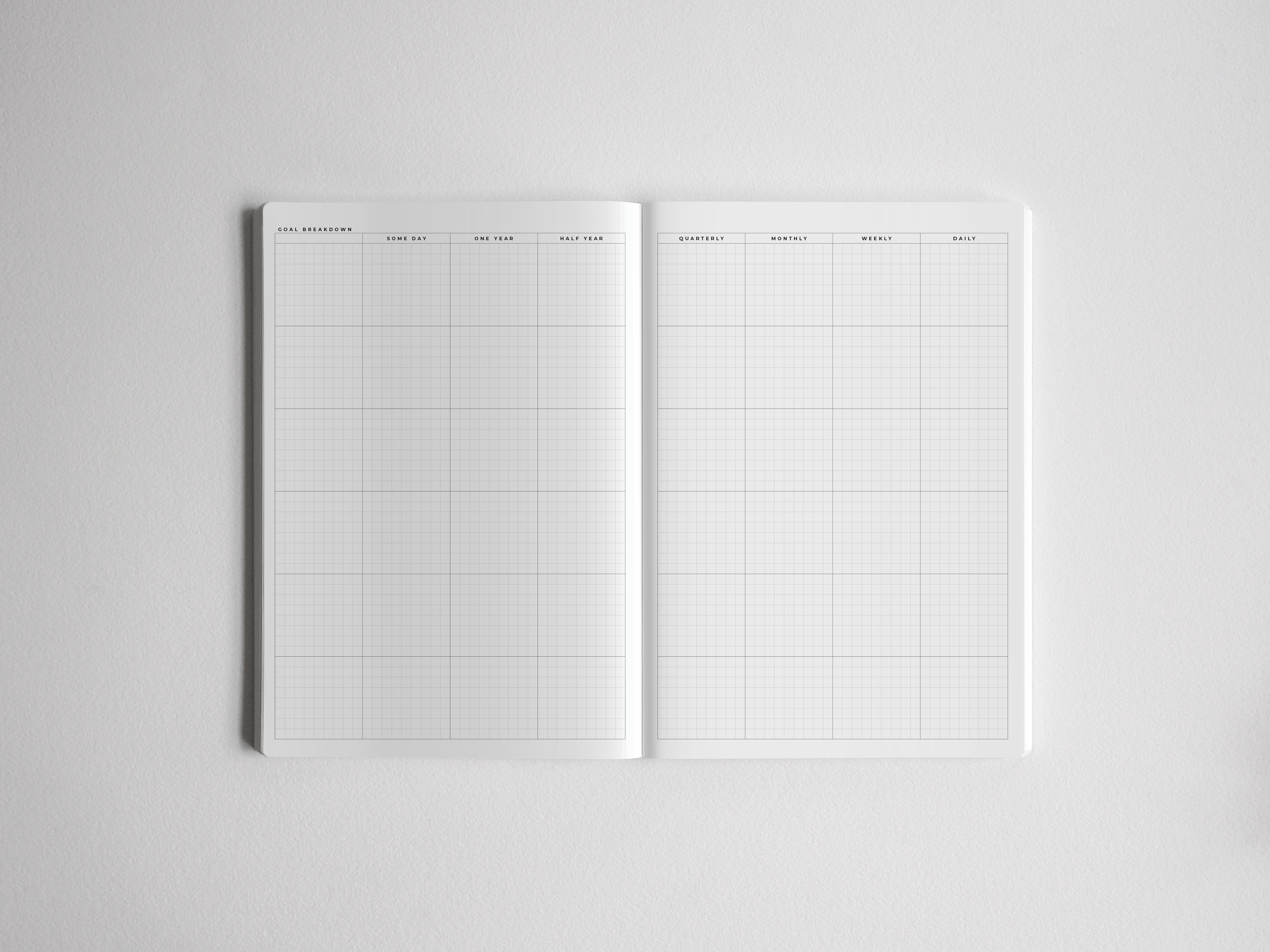Open A5 academic planner featuring a clean, structured white grid layout for comprehensive vertical planning over a full year, including daily and quarterly sections.