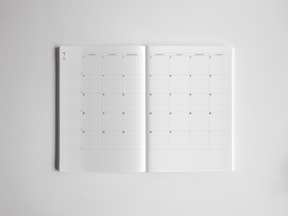 Open A5 academic daily planner displaying a structured, gridded layout with labeled columns for comprehensive weekly planning and year-long organization.