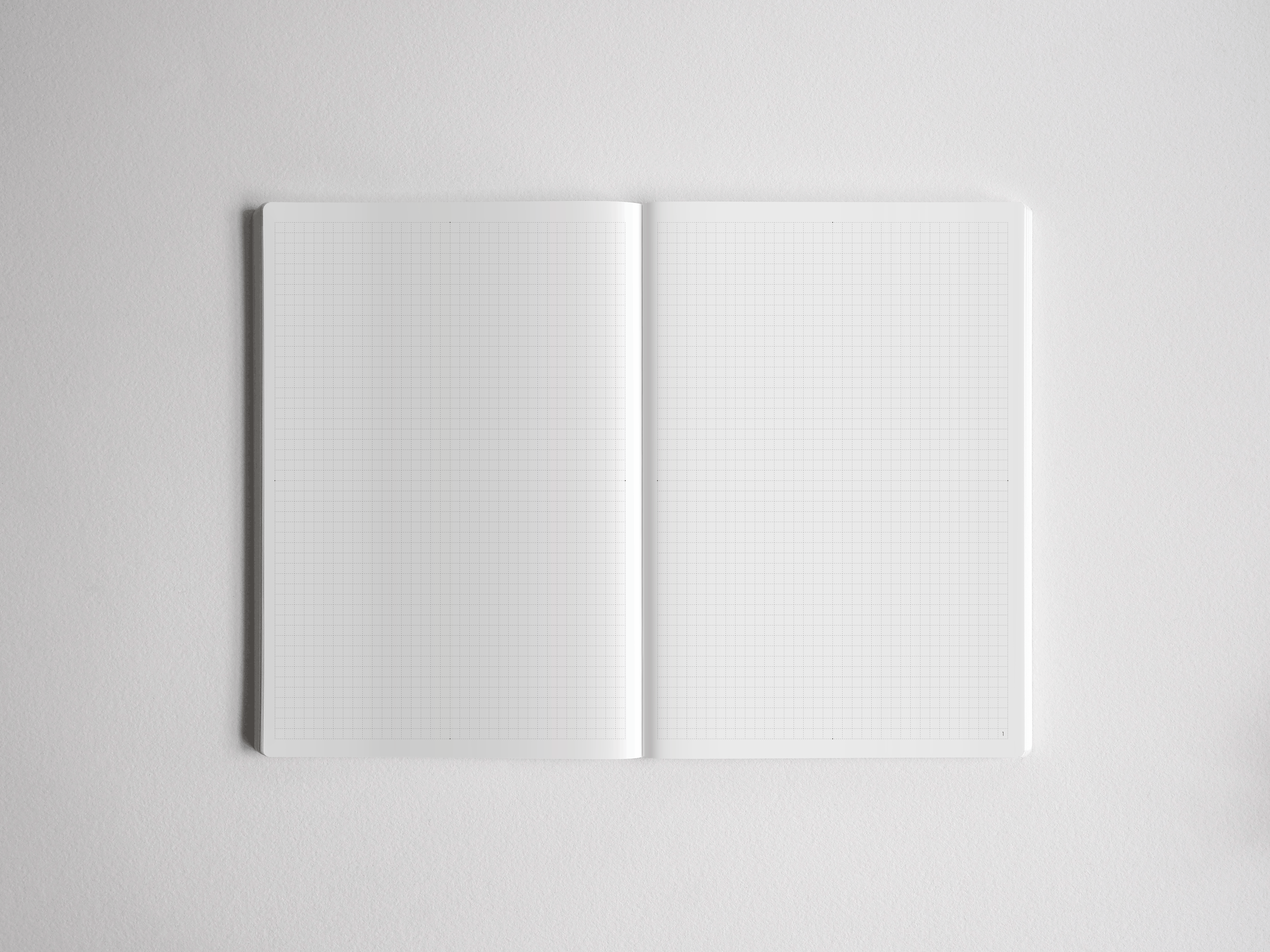 Open academic planner showing two blank pages printed with a light gray, functional graph paper grid perfect for planning and detailed note-taking.