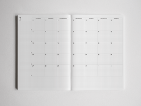 Open B5 academic planner featuring a clean, vertical grid layout for detailed monthly scheduling, structured for the full 2026-2027 academic year.