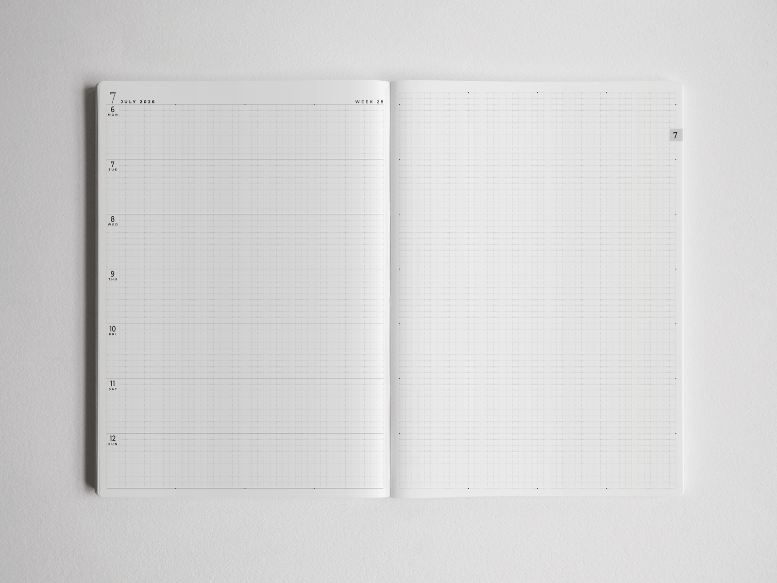 Open B5 academic planner detailing dated schedules and complemented by blank graph paper, providing versatile, comprehensive space for full-year study planning.