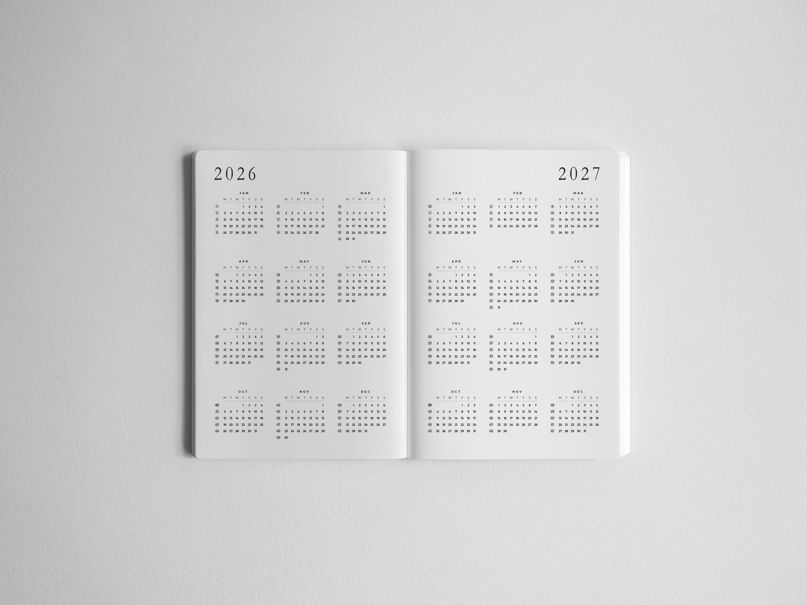 Structured B6 academic planner displaying minimalist, full-year calendar grids for 2026 and 2027, perfect for tracking academic schedules.