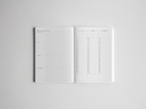 A vertically oriented B6 academic planner open to a monthly calendar spread with crisp white ruled pages for detailed year planning and organization.