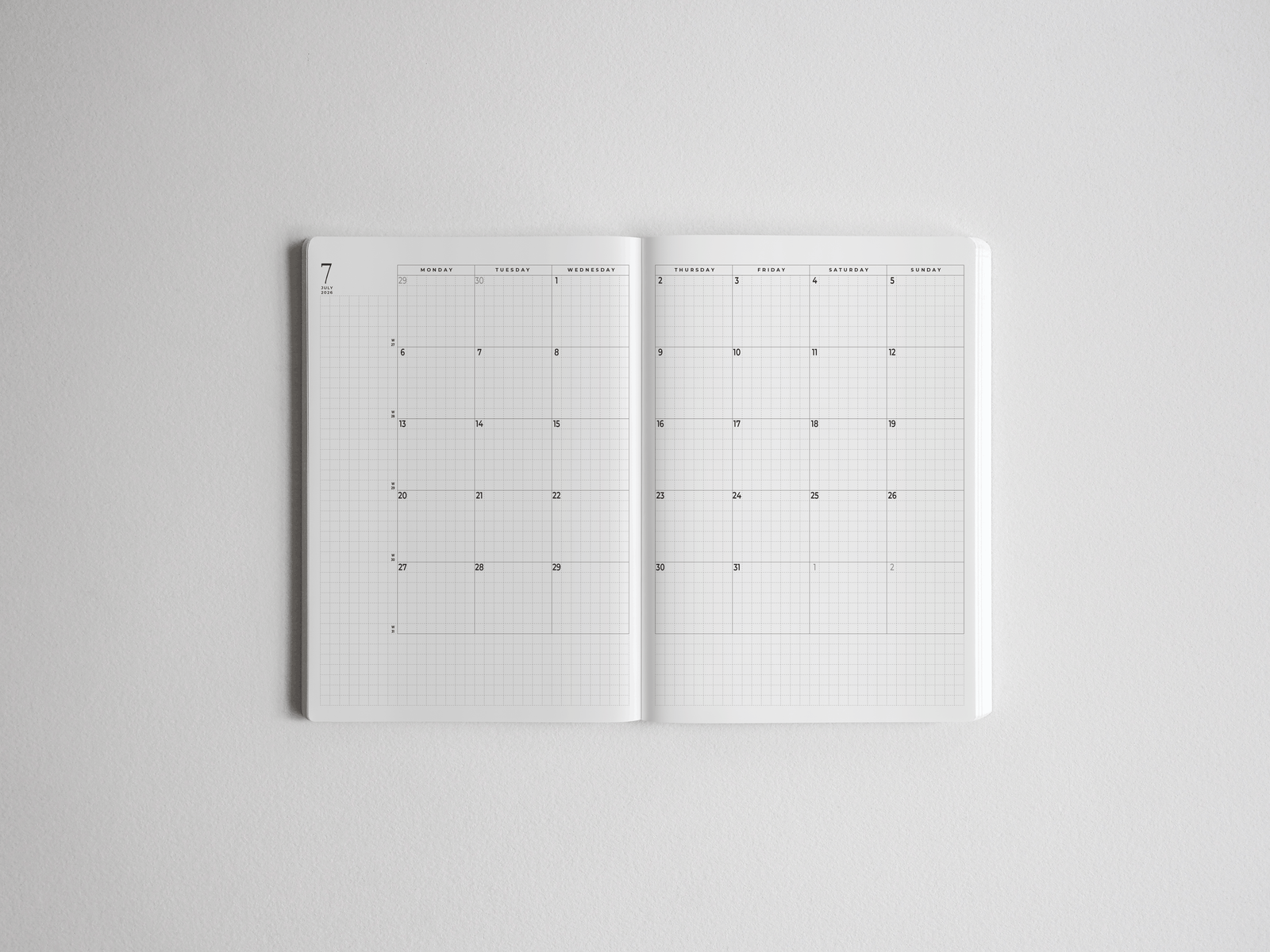 White daily planner open to a monthly academic calendar view, featuring structured grid lines and dated sections for year-long organizing.