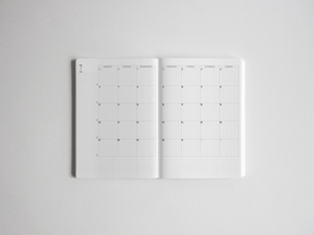 Open B6 academic planner featuring gridded horizontal weekly spreads with clear, organized layouts for comprehensive academic and yearly scheduling.