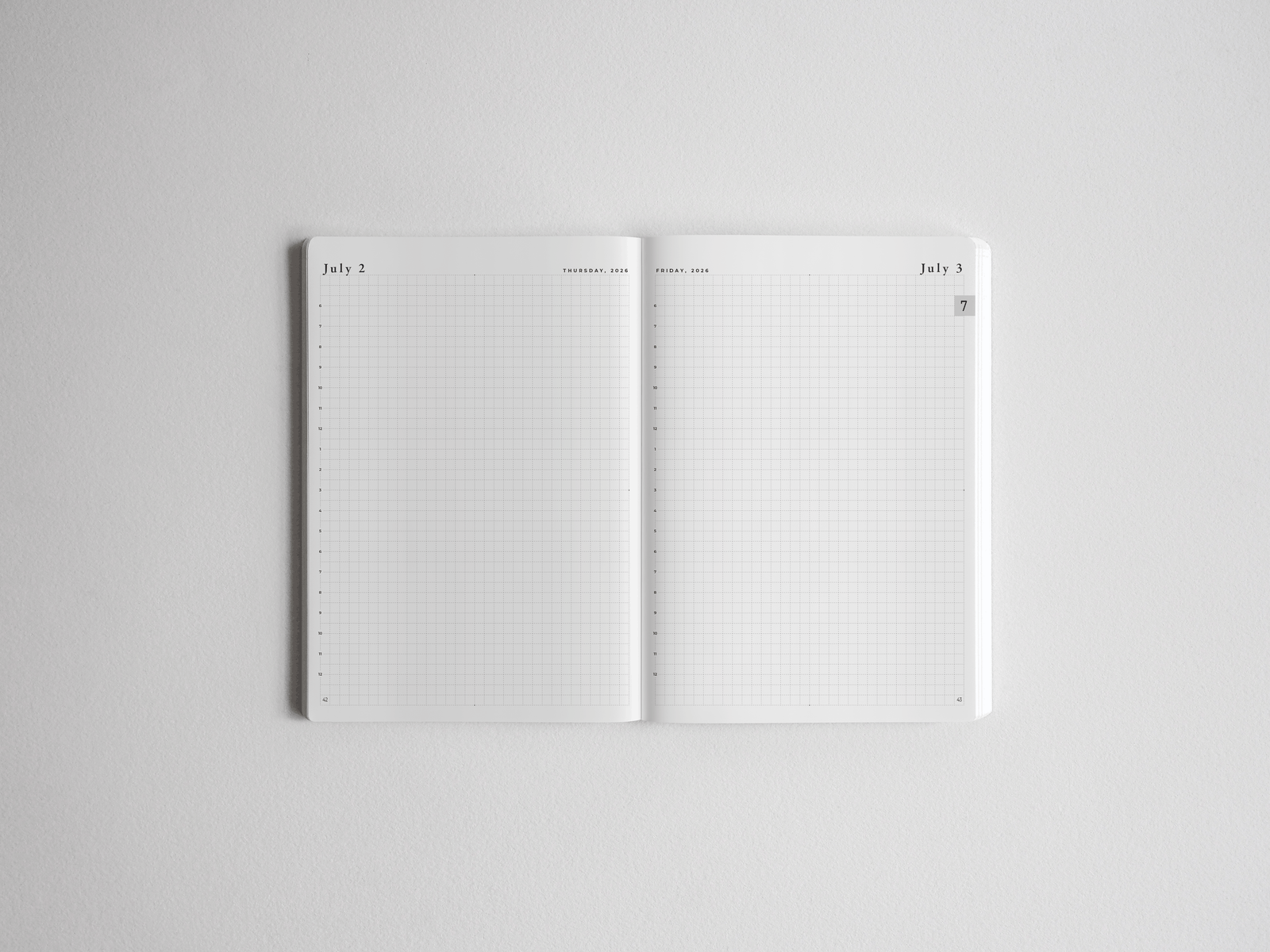 Open academic daily planner spread featuring crisp white pages with fine-lined graph paper grids and dated headers for structured scheduling.