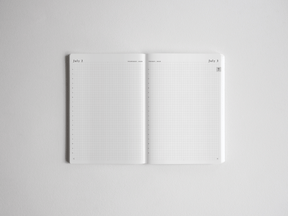 Open academic daily planner spread featuring crisp white pages with fine-lined graph paper grids and dated headers for structured scheduling.