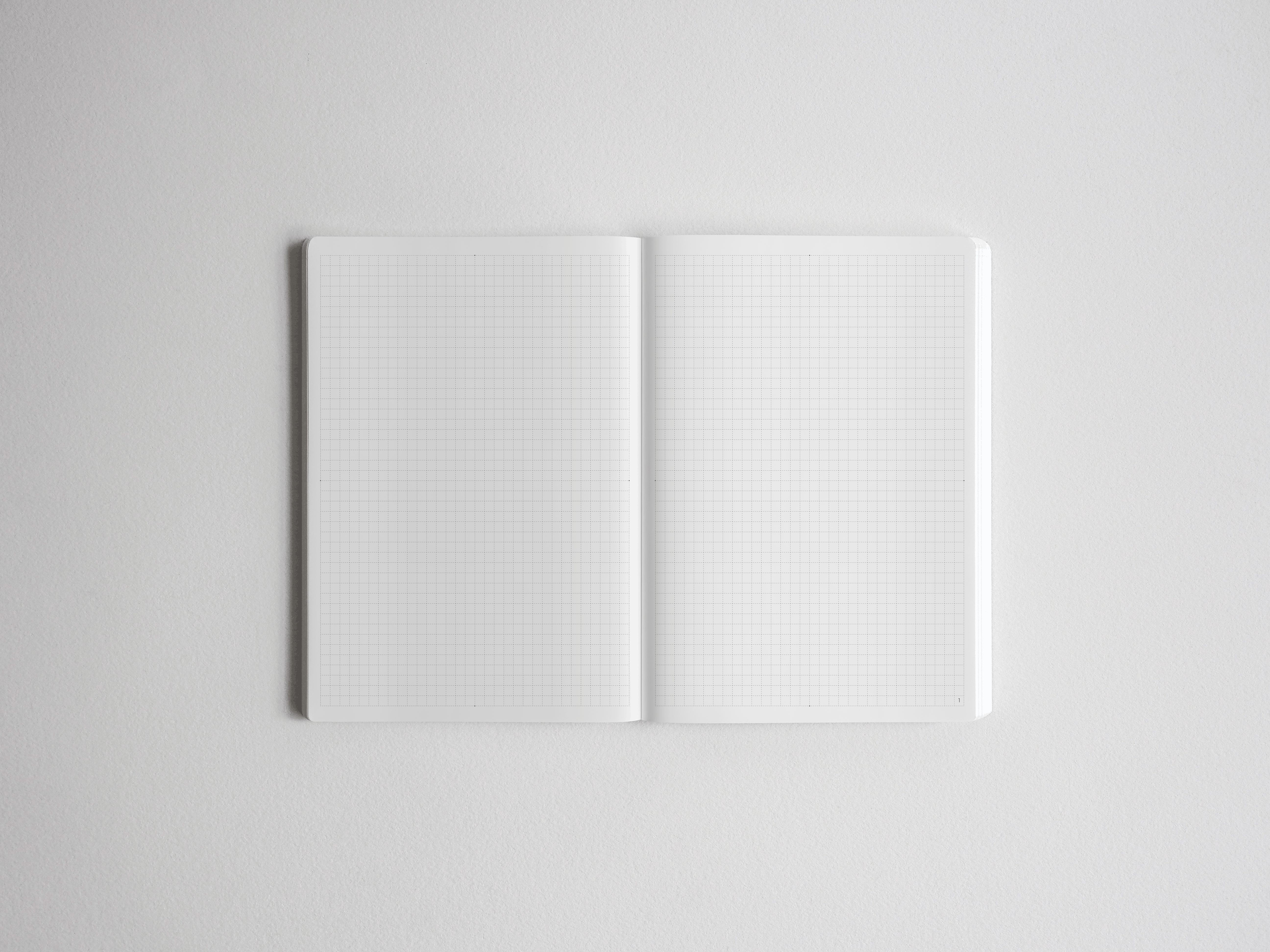 Open academic planner showcasing two pages of light gray grid graph paper, perfect for structured note-taking, journaling, and year-long planning.