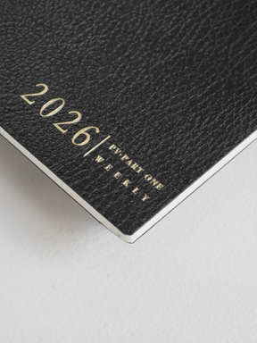 Minimalist black weekly planner cover featuring elegant debossed metallic lettering for "2026 | PV PART ONE WEEKLY."
