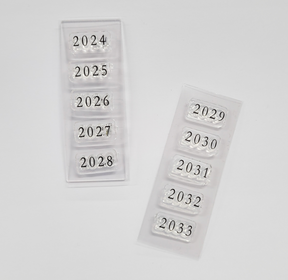 Organized set of year stamps in clear plastic trays, displaying years 2024 through 2033 for diary and planner journaling.