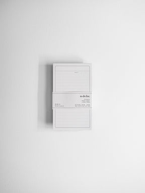 Minimalist white notepad designed for task management, featuring structured ruled lines and a dedicated "to do list" header for daily planning.